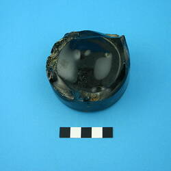 One glass bottle base, dark green.