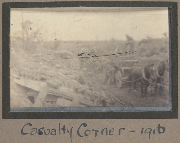 Horse drawn cartridge and people near a large pile of debris.