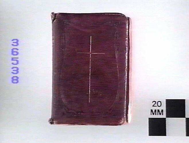 Leather bound book with cross on front cover.