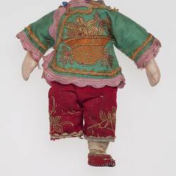 Headless doll dressed in green and red Chinese costume.