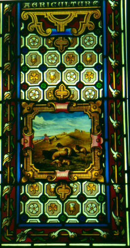 Stained glass window showing an agricultural scene.