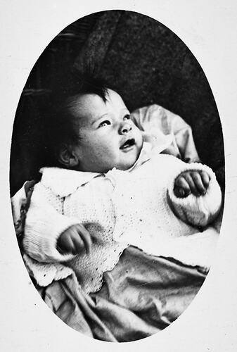 Oval portrait of a baby girl.