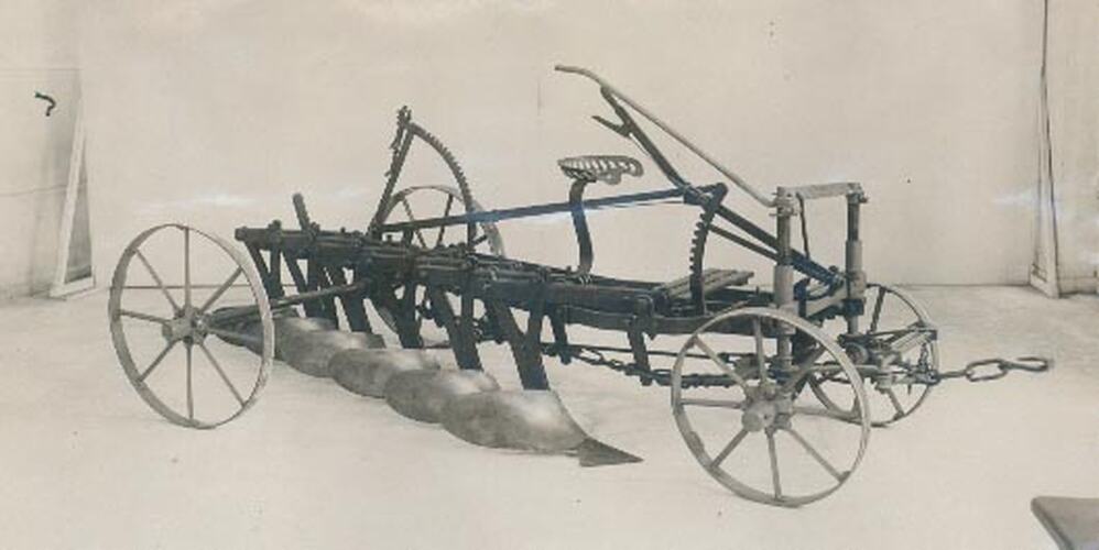Studio photograph of front right hand side of a mouldboard plough.