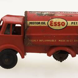 Red toy 'motor oil' truck, left view.