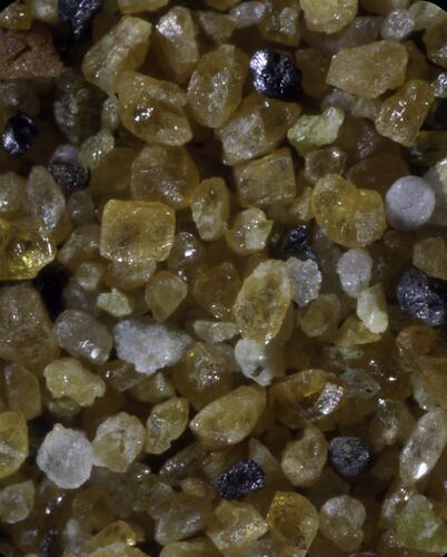 Uncut orange-yellow crystal grains.