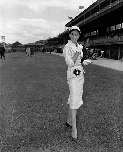 Woman next to Grandstand, Flemington Racecourse, Victoria, 1954-1955