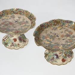 Pair of cream coloured compote with wavy edges decorated with birds & chrysanthemums.