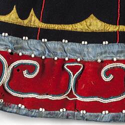 Detail of black fabric with red embroidery.