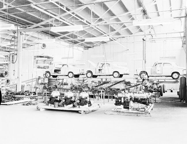 Monochrome photograph of a vehicle manufacturing plant.