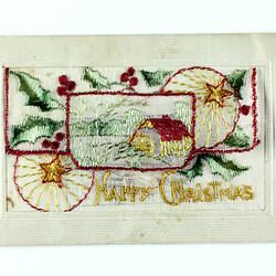 Front of embroidered postcard with Christmas scene.