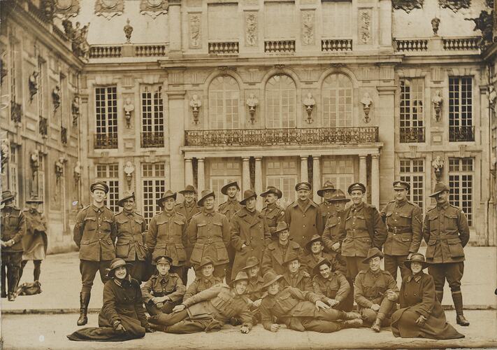 Men and women in military uniform, large building.