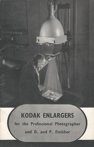 Cover page with image of man using enlarger.