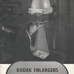 Cover page with image of man using enlarger.