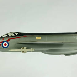 Silver model aeroplane. Blue, white and red rondels on wings and fuselage. Profile.