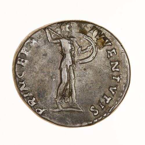 Round coin, aged, figure holding out shiled and drawing spear.