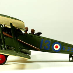 Dark green aeroplane model with red, white, blue circles. Left profile.