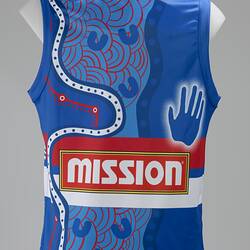 Back of blue sleeveless football jumper. Red and white mid section with text. White Aboriginal dot pattern.