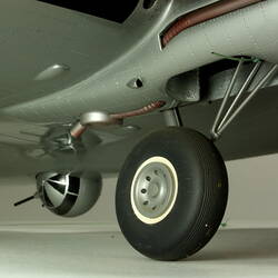 Silver model aeroplane. Detail of wheel gear.