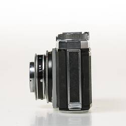 Chrome metal and black leather viewfinder camera. Left profile.