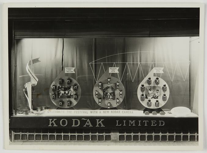 Kodak display case with products, photographs and signage arranged within.