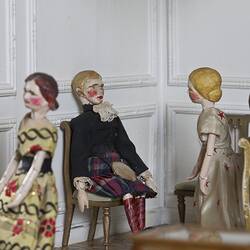 Doll's house interior room. Furnished and featuring costumed figures.