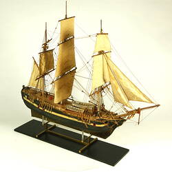 Wooden ship with three masts, three quarter view.