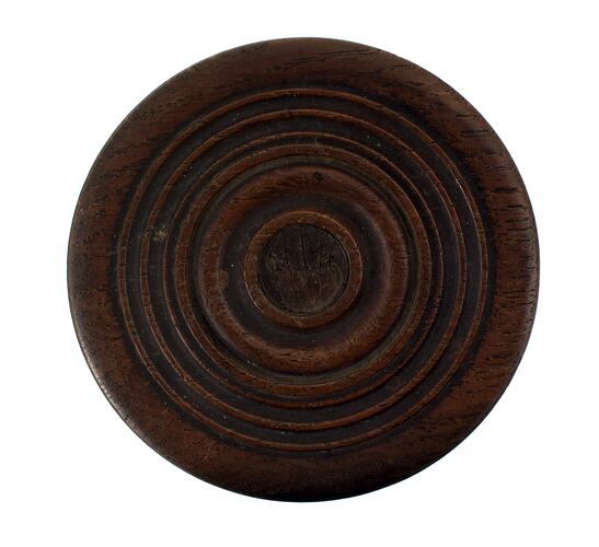 Circular box of wood, turned, with concentric circles on the lid.