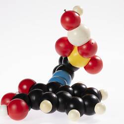 3D plastic model of molecular structure made up of coloured spheres.