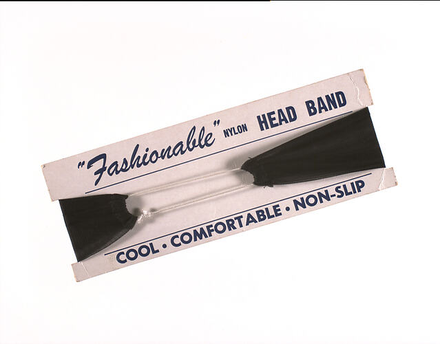 Black nylon headband on cardboard strip packaging.