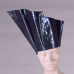 Blue metallic hat on mannequin.