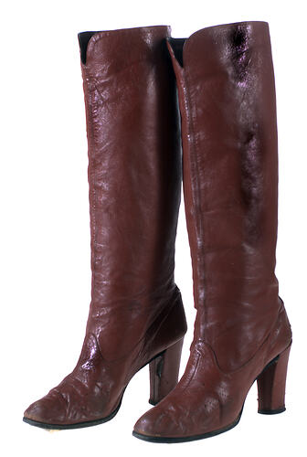 Brown leather women's tall high heeled boots.
