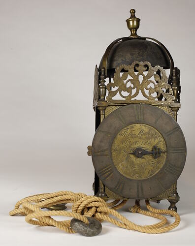 Rectangular metal clock with domed top.
