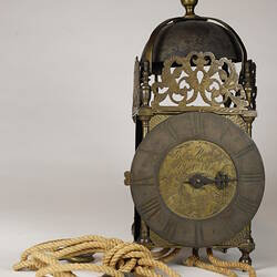 Rectangular metal clock with domed top.
