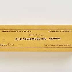 Rectangular cardboard box with yellow-coloured paper label. Label has black printed text.