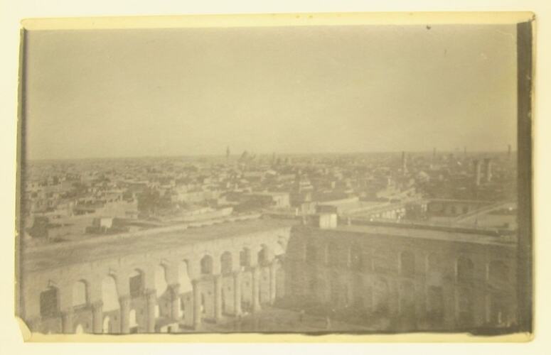 View of a Middle Eastern city, town square in foreground.