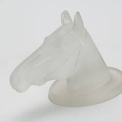 Glass horse head shaped paperweight.