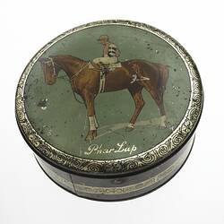 Cake tin with picture of race horse.