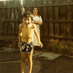 Woman Spraying Boy with Hose, Backyard, Footscray, circa 1980