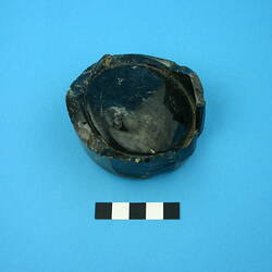 One glass bottle base, dark green.