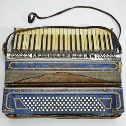Blue piano accordion with Ivory keys.
