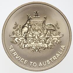 Round gold medal with raised Australian Coat of Arms and text below.