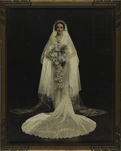 Wedding photograph of a bride with a lace veil and train.