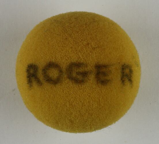 Yellow sponge ball with Roger written on it.
