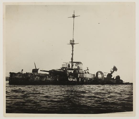 Wreckage of a battleship on water.