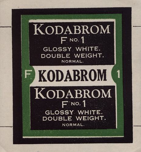 Black and white paper label with green border.