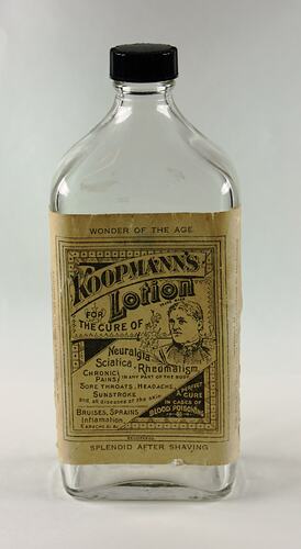 Clear glass oblong medicine bottle with plastic screw-top. Woman and text on label.