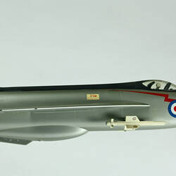 Silver model aeroplane. Blue, white and red rondels on wings and fuselage. Profile.