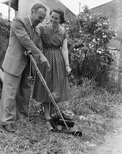 H. G. Palmer Pty Ltd, Man and Woman with Lawn Mower, Melbourne, Victoria, Oct 1958