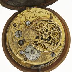 Pocket watch case, open showing decorative mechanism and engraving.