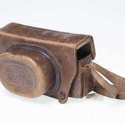 Tan leather camera carry case with strap.